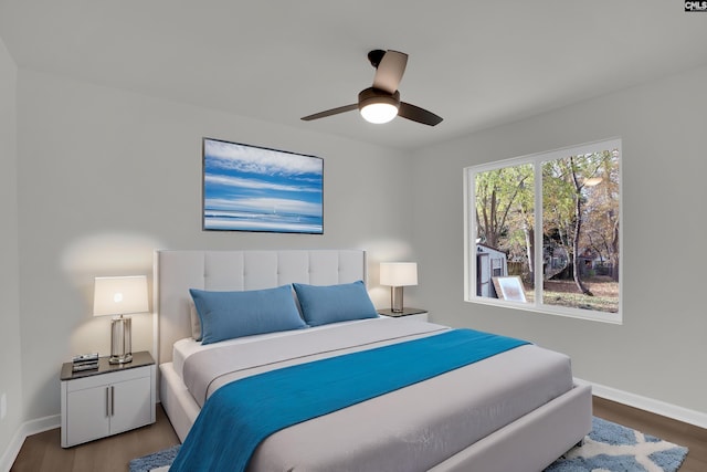 bedroom with dark hardwood / wood-style flooring and ceiling fan