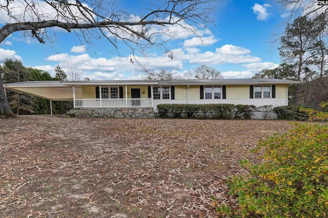 ranch-style house with covered porch and a carport