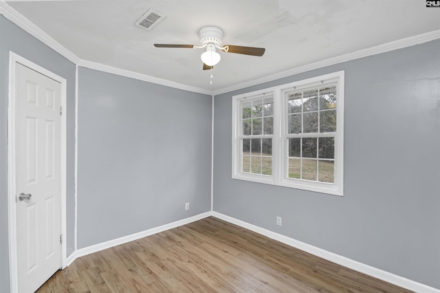 empty room featuring light hardwood / wood-style flooring, ceiling fan, and ornamental molding