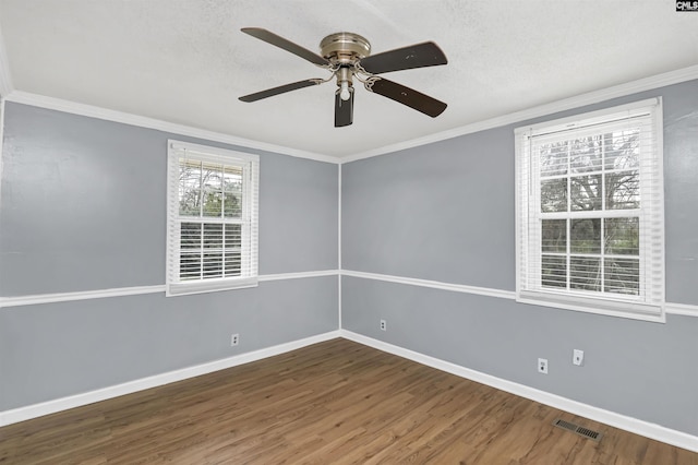 spare room with ceiling fan, crown molding, and dark hardwood / wood-style floors