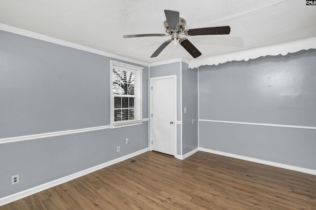 unfurnished room with a textured ceiling, ceiling fan, dark hardwood / wood-style floors, and ornamental molding