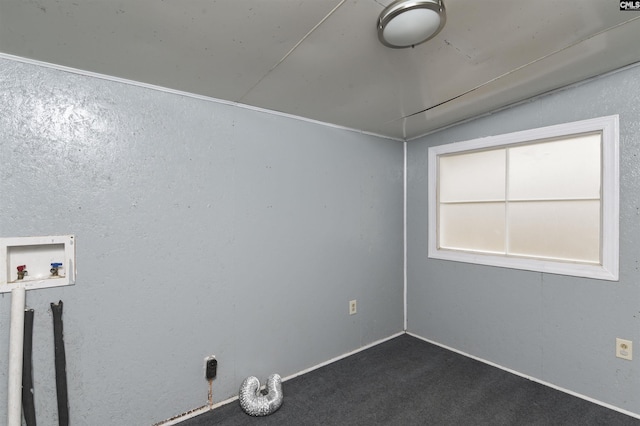 spare room featuring dark colored carpet