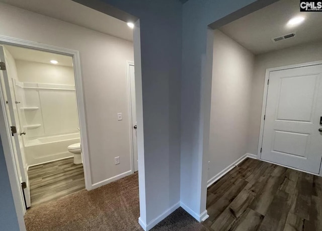 hallway with dark wood-type flooring