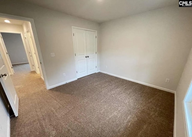 unfurnished bedroom with carpet floors and a closet