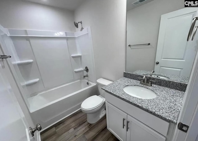 full bathroom with hardwood / wood-style flooring, shower / bathing tub combination, vanity, and toilet