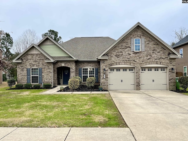 view of front of house with a front yard and a garage