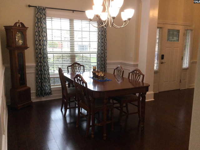 dining area featuring a notable chandelier and dark hardwood / wood-style floors