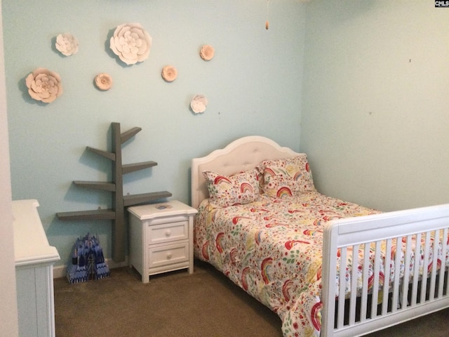 bedroom featuring dark carpet