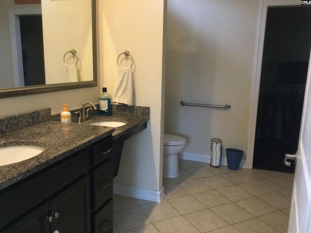 bathroom featuring vanity, tile patterned floors, and toilet