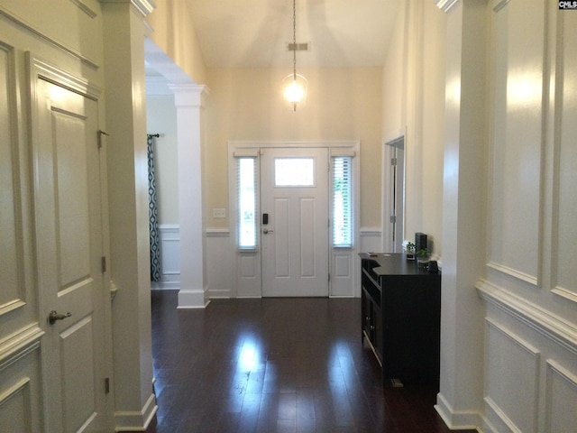 entryway with dark wood-type flooring and ornate columns