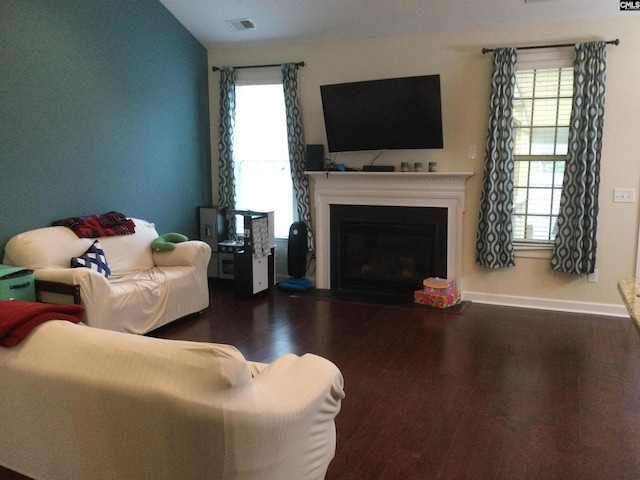 living room with vaulted ceiling and dark hardwood / wood-style floors