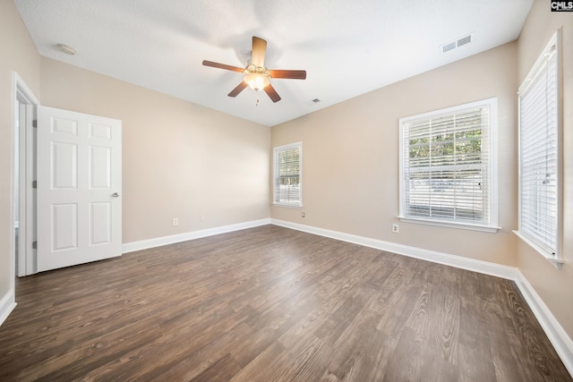 unfurnished room featuring ceiling fan and dark wood-type flooring