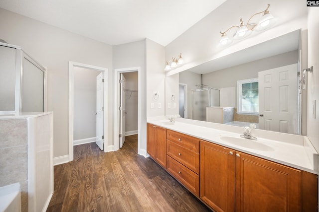 bathroom featuring hardwood / wood-style floors, vanity, and separate shower and tub