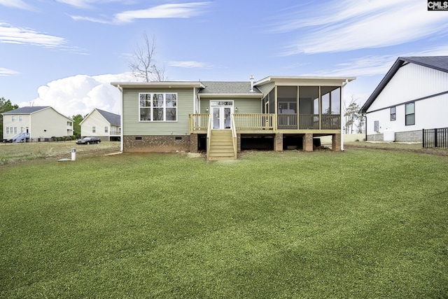 back of house featuring a yard, a wooden deck, and a sunroom