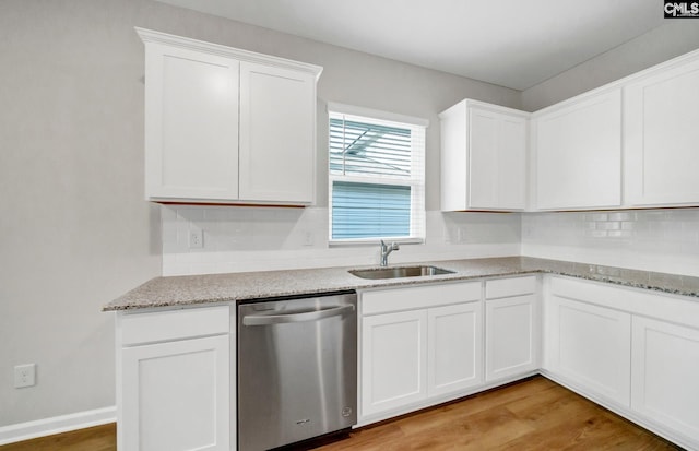 kitchen featuring dishwasher, sink, light stone countertops, light wood-type flooring, and white cabinetry