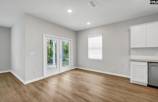 unfurnished dining area with light wood-type flooring