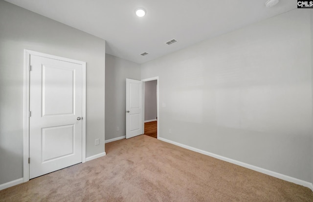 unfurnished bedroom featuring light colored carpet