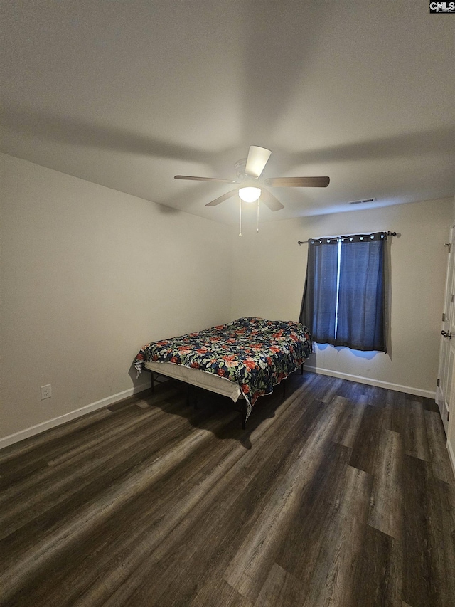 bedroom featuring ceiling fan and dark wood-type flooring