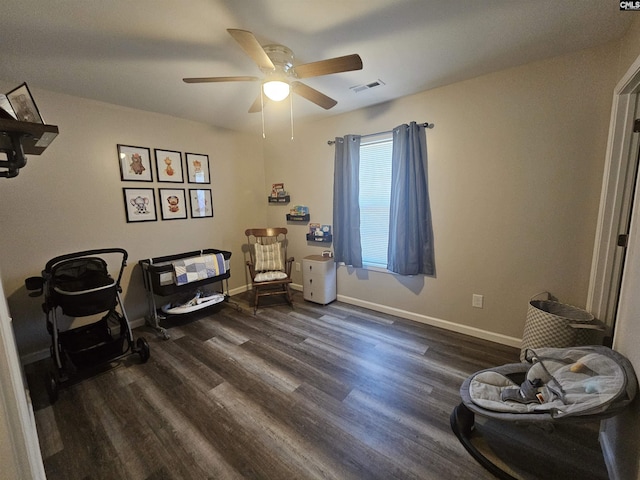 sitting room with dark hardwood / wood-style floors and ceiling fan