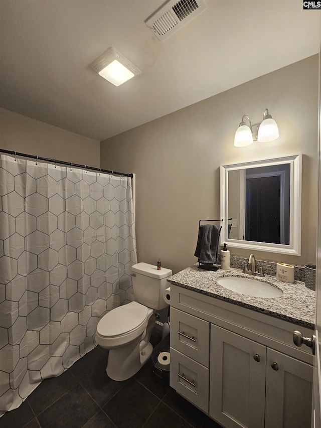 bathroom with tile patterned flooring, vanity, toilet, and curtained shower