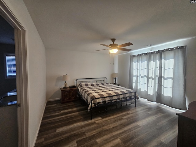 bedroom featuring ceiling fan and dark hardwood / wood-style floors