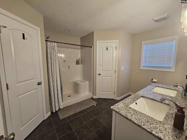 bathroom with curtained shower, tile patterned flooring, and vanity