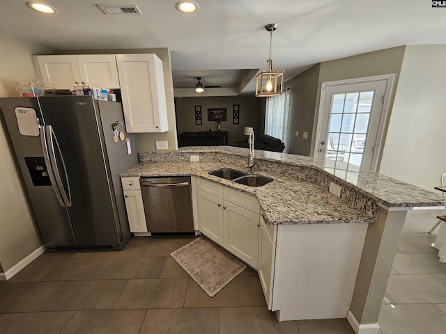 kitchen with kitchen peninsula, stainless steel appliances, ceiling fan, sink, and white cabinetry