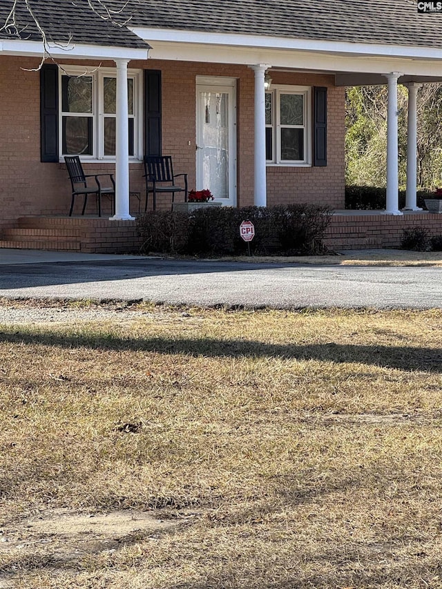 view of exterior entry with a porch