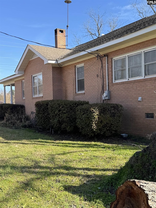 view of property exterior with a yard