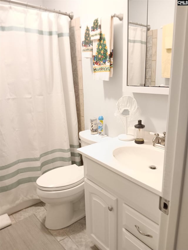 bathroom featuring tile patterned flooring, vanity, toilet, and a shower with shower curtain