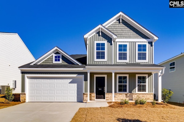 craftsman inspired home featuring covered porch, central AC, and a garage