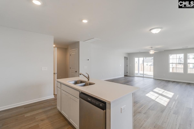 kitchen with stainless steel dishwasher, ceiling fan, sink, a center island with sink, and white cabinetry