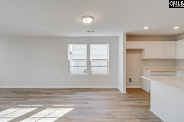 kitchen with white cabinets and light wood-type flooring