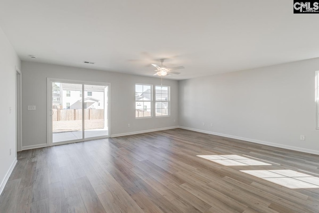 spare room featuring light hardwood / wood-style floors and ceiling fan