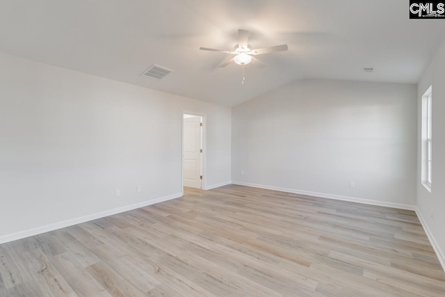 spare room with ceiling fan, light hardwood / wood-style floors, and vaulted ceiling