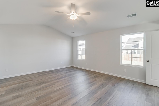 unfurnished room with ceiling fan, lofted ceiling, and light hardwood / wood-style flooring