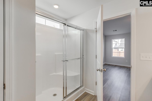 bathroom featuring hardwood / wood-style floors and walk in shower