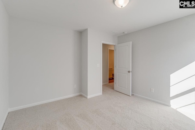 unfurnished room featuring light colored carpet