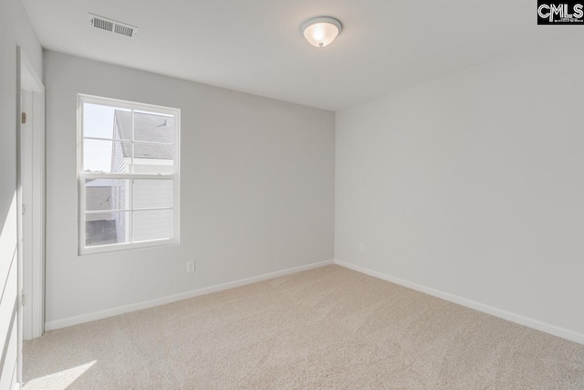 spare room with light colored carpet