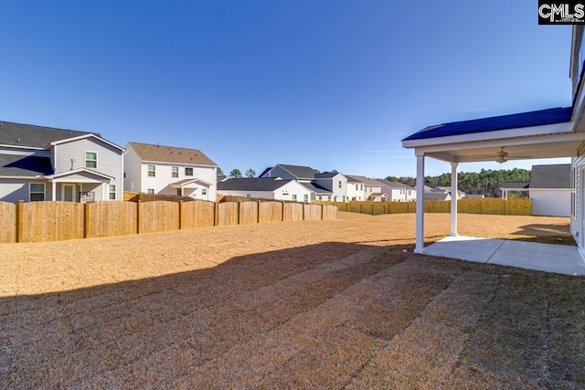 view of yard with ceiling fan and a patio