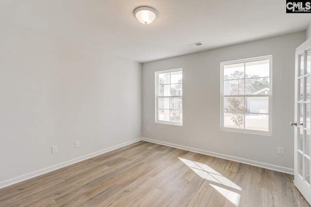 spare room featuring light hardwood / wood-style floors