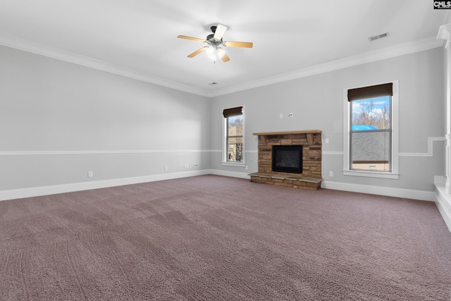 unfurnished living room featuring ceiling fan, a fireplace, carpet floors, and ornamental molding