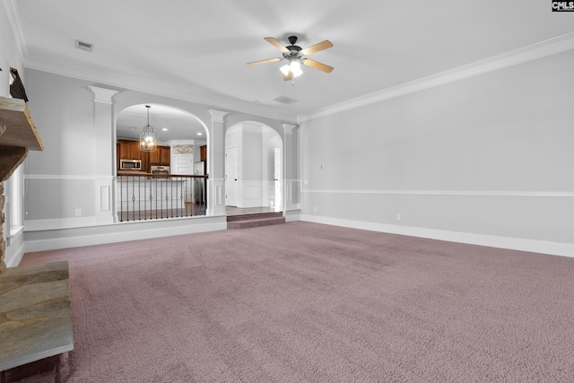 unfurnished living room with carpet, ceiling fan with notable chandelier, crown molding, and decorative columns