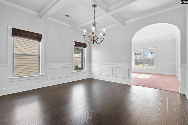 spare room featuring coffered ceiling, beamed ceiling, dark hardwood / wood-style floors, crown molding, and a chandelier