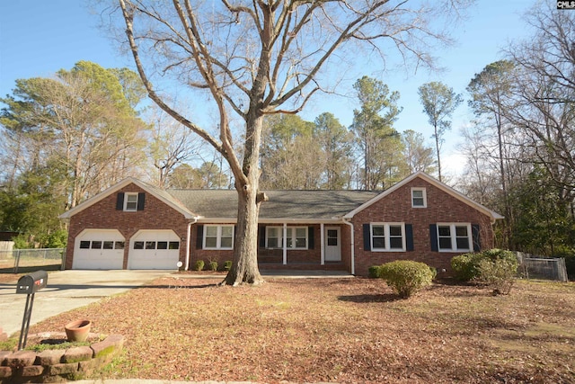 single story home featuring covered porch and a garage