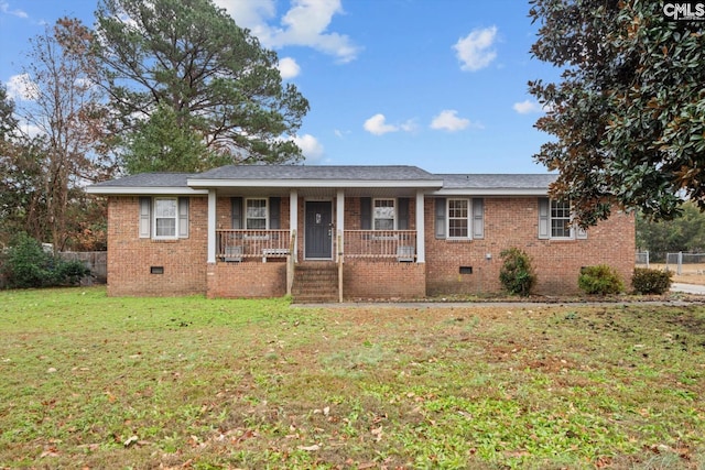 ranch-style house with covered porch and a front yard