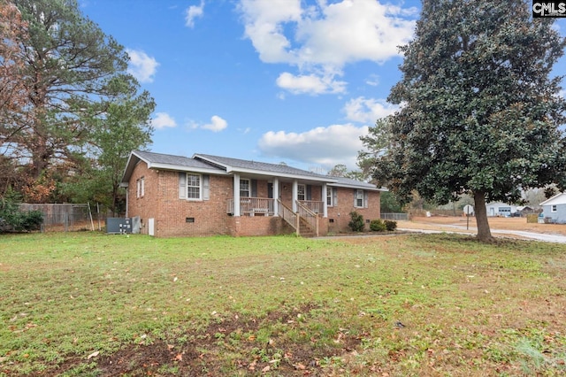 view of front of house with a front yard and central AC