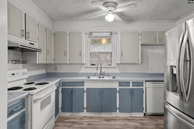 kitchen with backsplash, a textured ceiling, white appliances, ceiling fan, and sink