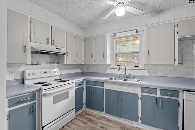 kitchen with light wood-type flooring, white appliances, a textured ceiling, sink, and white cabinets