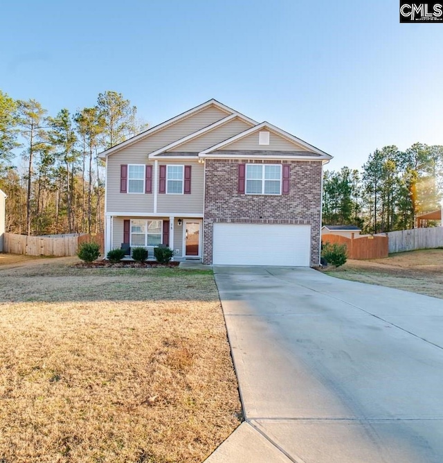 view of front of property featuring a garage and a front yard